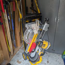 12" DeWalt sliding miter saw with stand and several blades