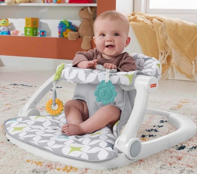Floor seat with development toys and machine washable seat pad