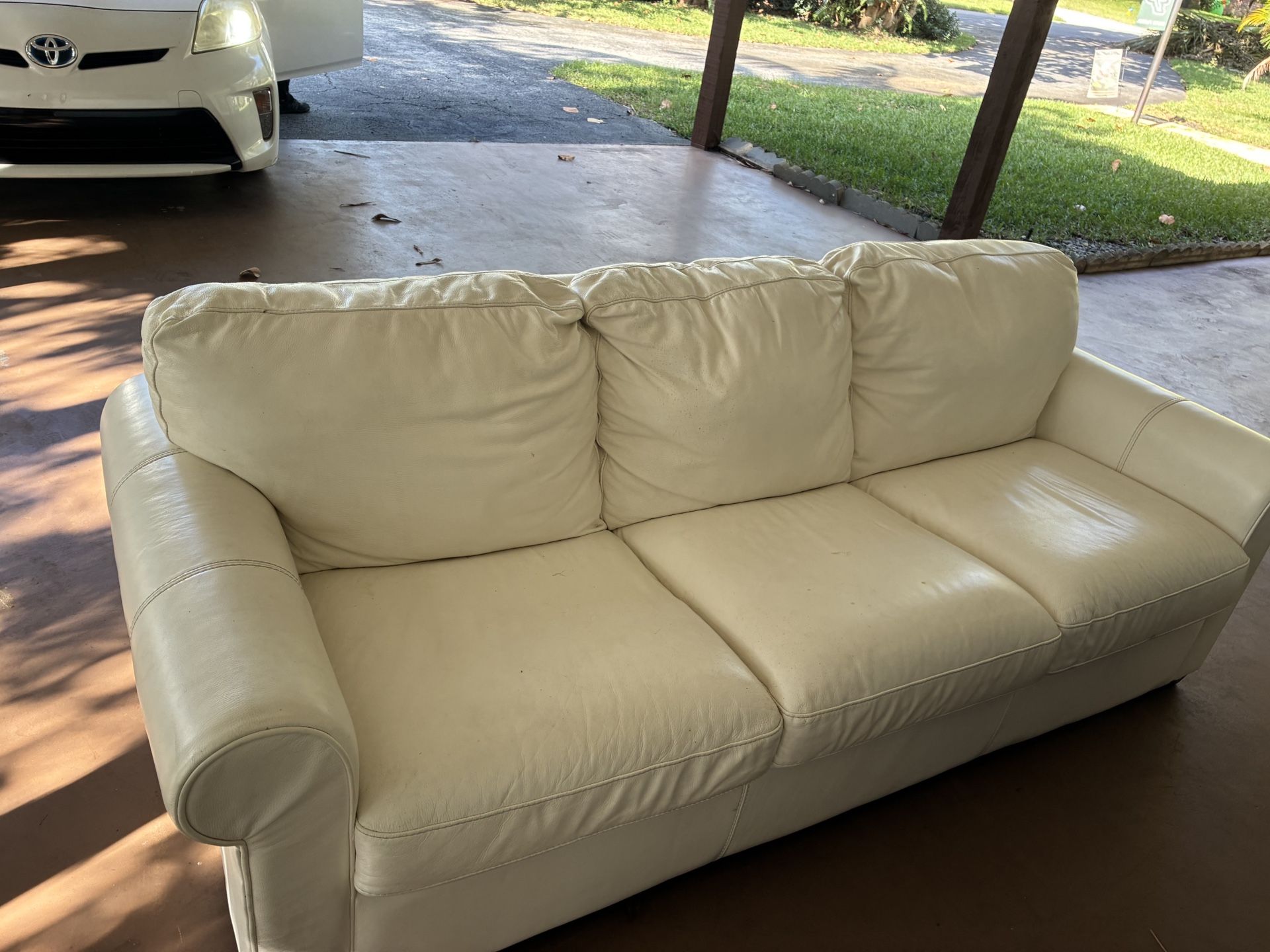 Cream colored 100% butter leather sofa.