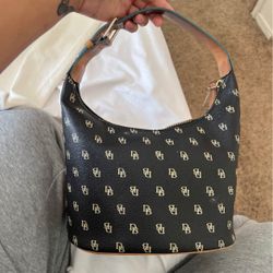 Dooney & Bourke logo bucket hobo purse  in black Coated with light blue trim