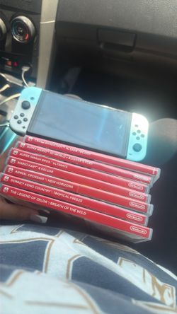 Nintendo switch Oled with games also games bought on device SpongeBob game god of war
