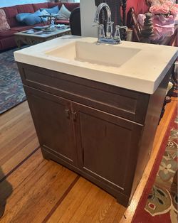 Bathroom, vanity cabinet, sink, and faucet
