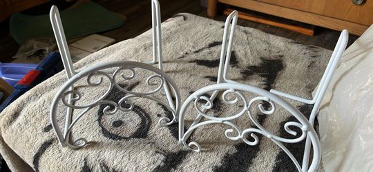 Two hose holders for a fence
