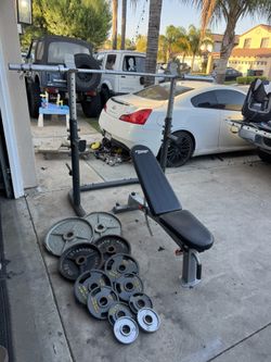 Bench press/squat rack with 245lbs of Olympic weights plus 7ft 3 piece 35lbs bar