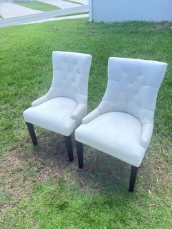Pair of tufted dining chairs.