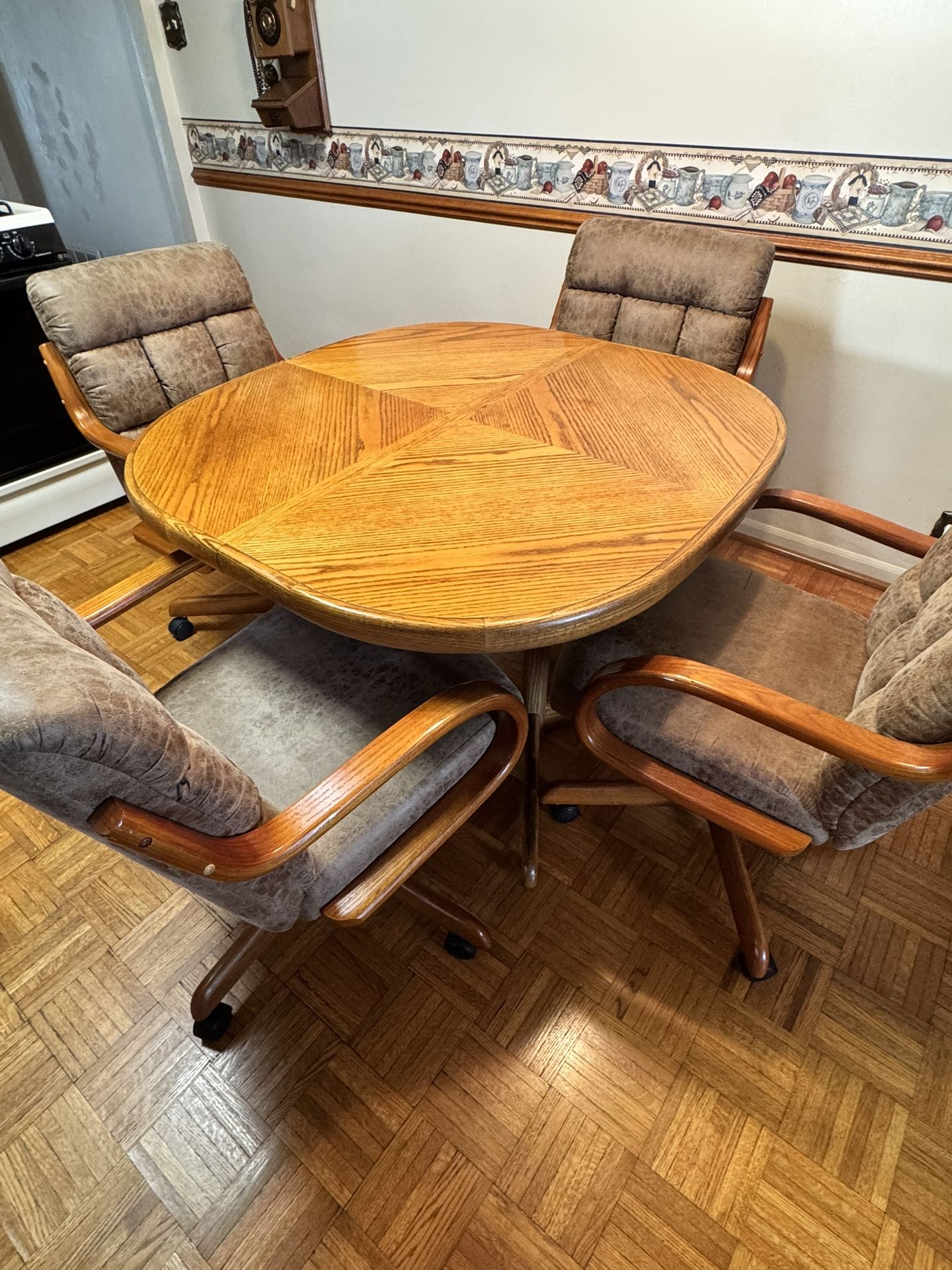 Solid Wood Kitchen Table With Four Rolling Chairs