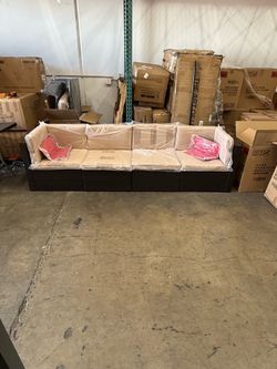 Beige Outdoor Wicker Sofa w/ Two Red Pillows