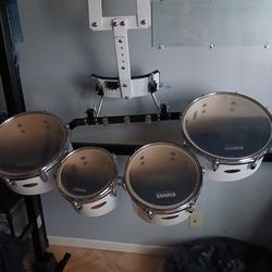 Drums a set of four tenor drums designed for marching bands. 