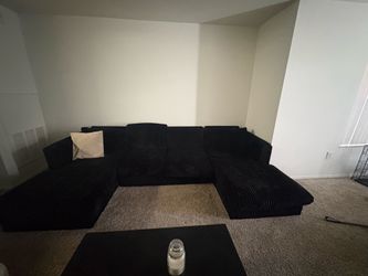 Black comfortable couch with pillows included