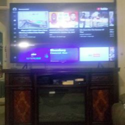 75 INCH.  SAMSUNG. 4K SMART TV.  WITH FIRE PLACE STAND