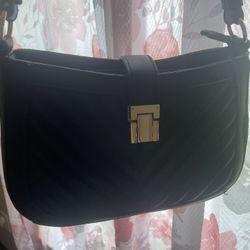 Black Handbag With Gold Accents And Leopard Print Inside 