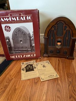 The General Electric (GE) Model 7-4100JA is a popular mid-1980s reproduction of a 1930s-style "cathedral" radio, often found with a wood veneer cabine