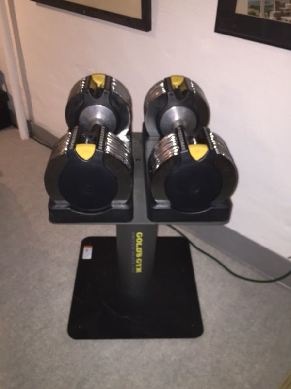 Golds Gym switch plate adjustable dumbbells with metal stand. In excellent condition. Each dumbbell adjustable from 10lbs to 50lbs in 5lb increments.