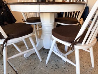 High-quality wood table with leaf-insert, four matching chairs, and chair cushions.