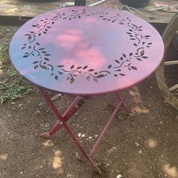 A metal table that folds up its   28 inches tall and26 inches across the top