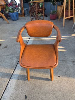 mid-century style accent chair upholstered in brown faux leather