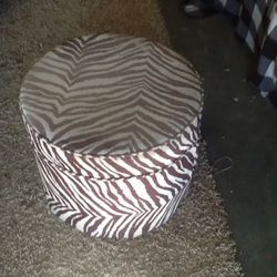 Small faded used zebra foot stool