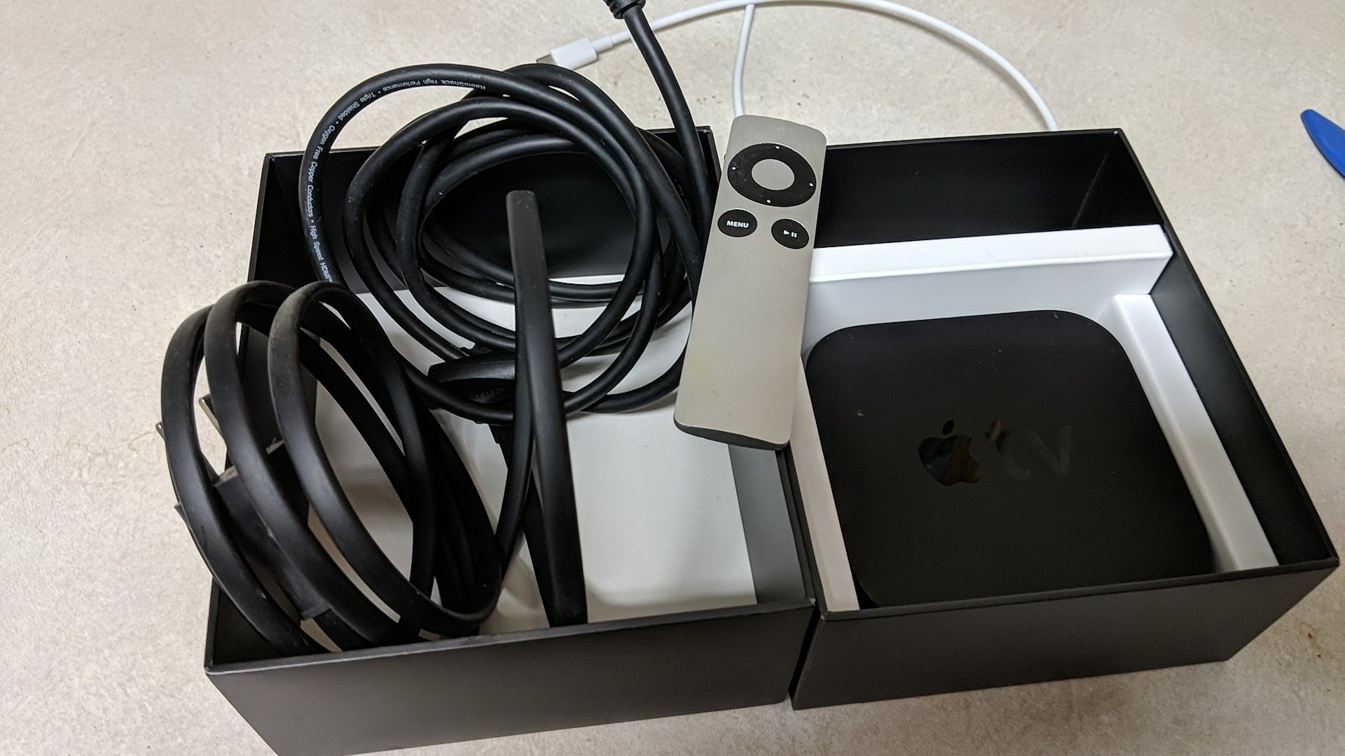 Apple TV streamer. HDMI cable included.