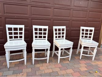 4 white high swivel chairs