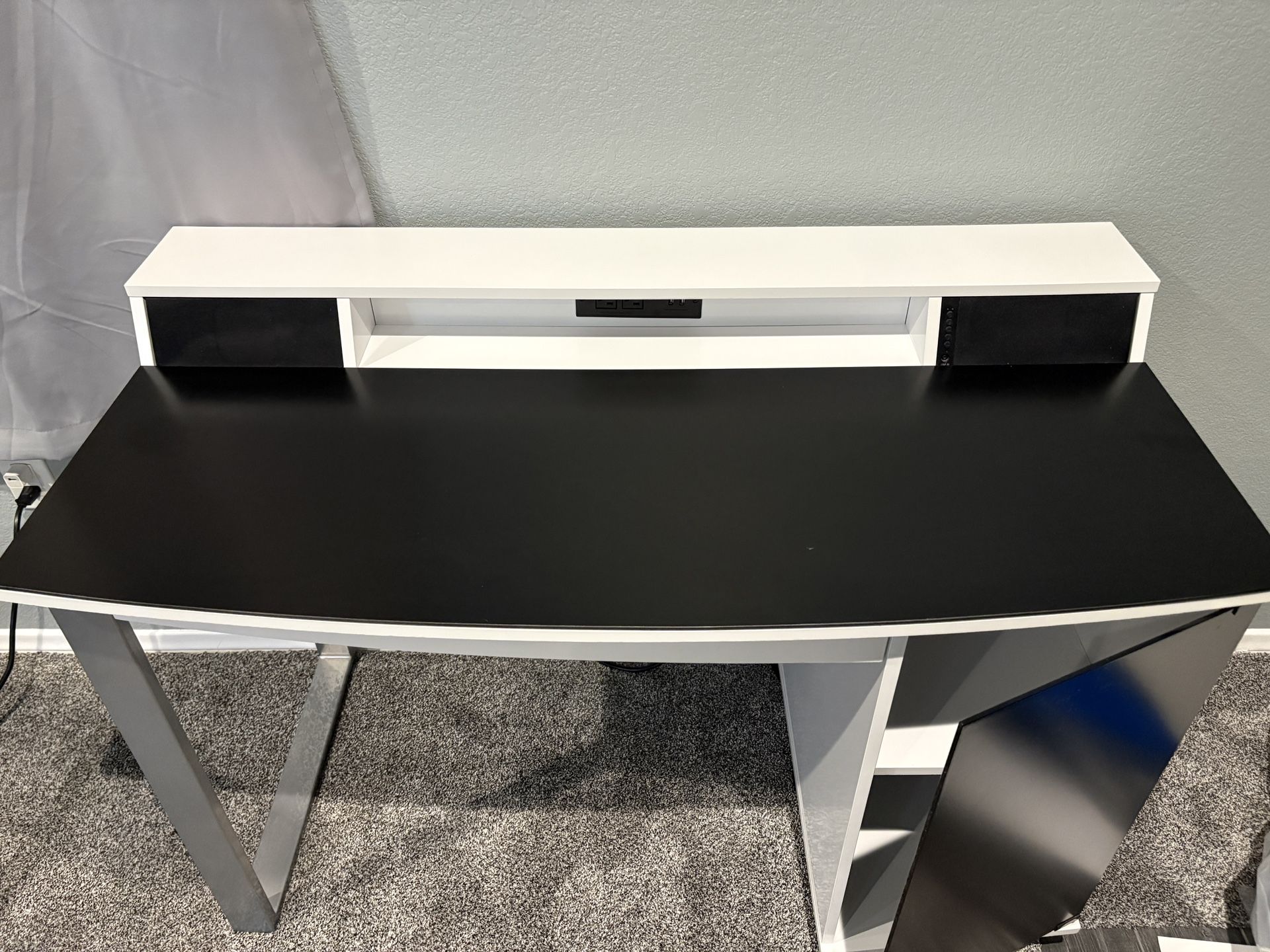 Bell'O Enterprise Desk with integrated Bluetooth speakers, charging station, and a black and white finish with silver legs 4ftx2ftx2’9”ft