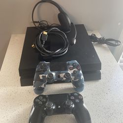 Playstation 4 with 2 controllers and a head set