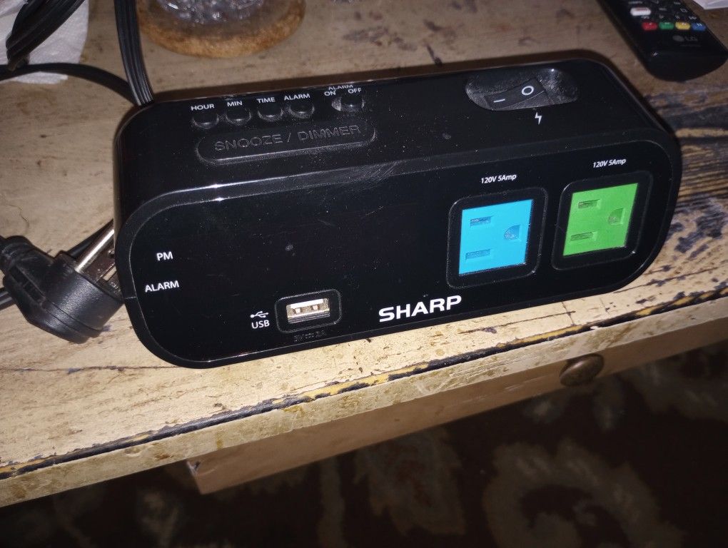 SHARP ALARM CLOCK WITH USB PORT AND 2 OUTLETS.