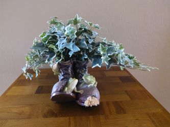 Artificial Plant In Pair Of Old Boots
