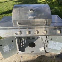 Nexgrill 4-burner stainless steel propane gas grill with a side burner.  It has four main stainless steel burners and one side burner.  The total cook