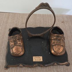 Photo frame with base, vintage style from the 1960s, featuring a bronze-plated baby shoe design. 9"W x 7"D x 5"H