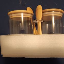 2 glass containers with little wooden spoons
