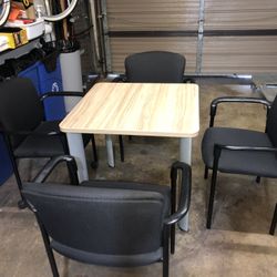 Table With 4 Black Stacking Chairs 