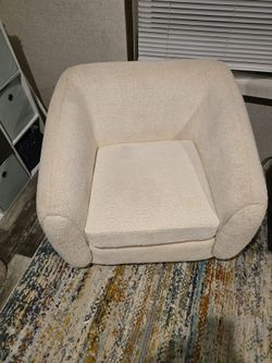 Two white boucle chairs