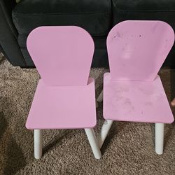 2 pink kids chairs