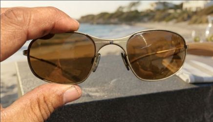 Oakley Square Wire 1.0 frames featuring a classic brushed metal finish and brown tinted lenses.