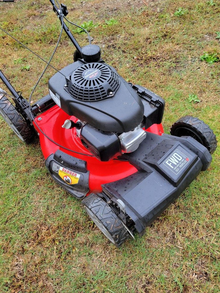 HONDA SELF PROPELLED. LIKE BRAND NEW. ONLY USED 3 TIMES. COST OVER 400.00. I.LL TAKE 250.00 BIG WHEELS ON BACK
