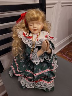 Praying porcelain doll