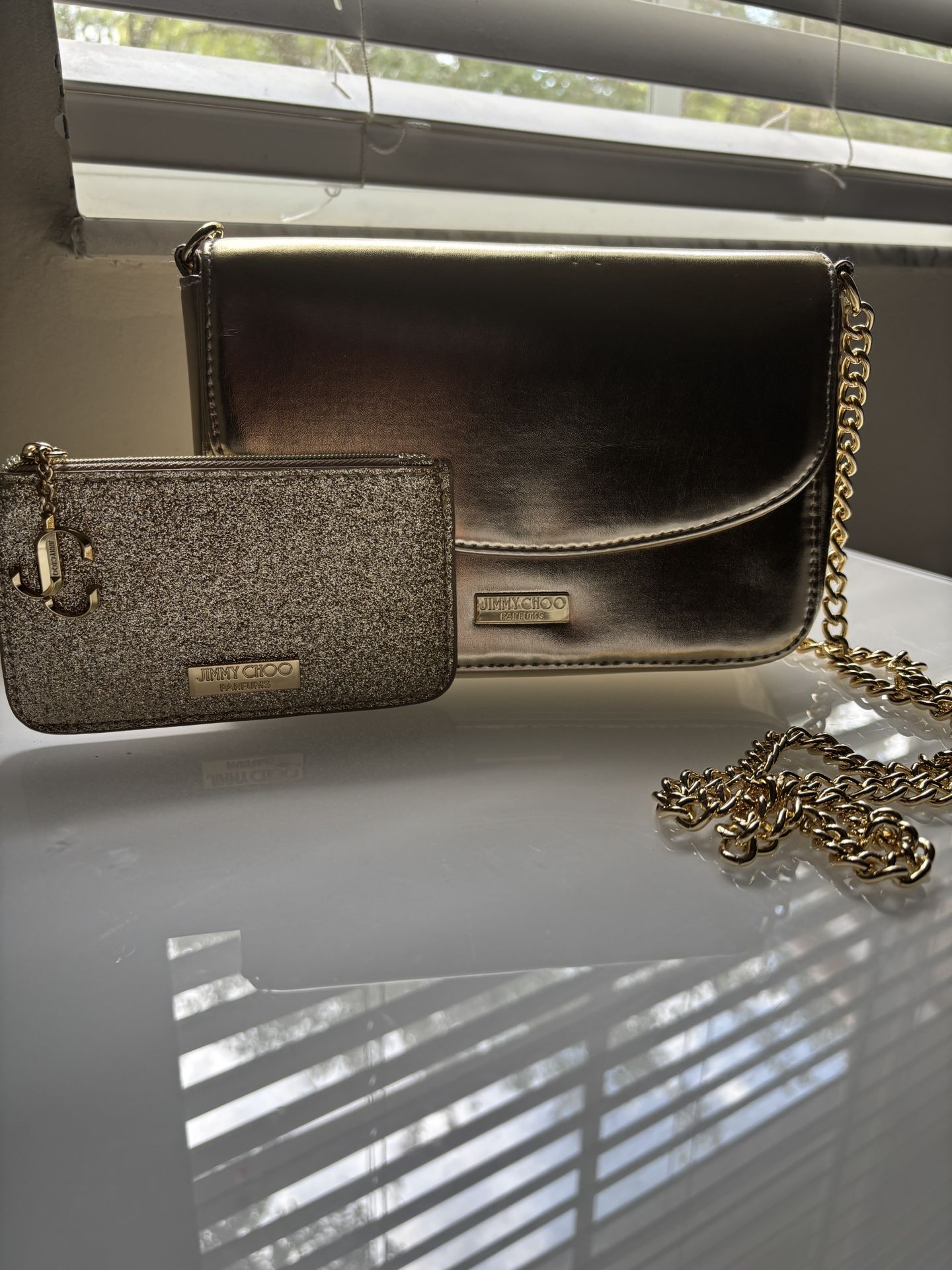 Jimmy Choo Gold Purse with Gold wallet/ Size of purse : small - medium/Size of wallet: Small/ Color of purse and wallet : Gold