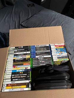 Box full of Xbox, PlayStation, DS, PC games