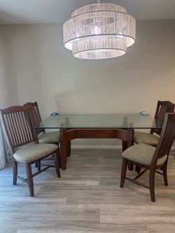 Glass top and solid wood table frame with 4 matching chairs