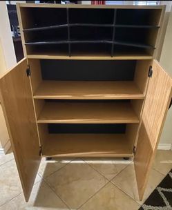 Two-door wooden cabinet with handles.