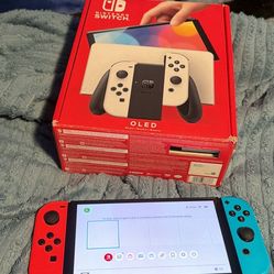 Nintendo switch OLA inbox with docking station, joy, con grip, HDMI, wrist, straps, and memory card