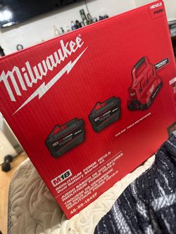 Brand new Milwaukee super fast fast charger with two batteries