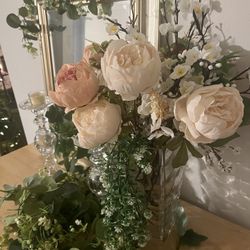 Beautiful faux flower arrangement for your home. Has light peach and pink peonies with pretty white flowers and greenery. Comes with the clear glass v