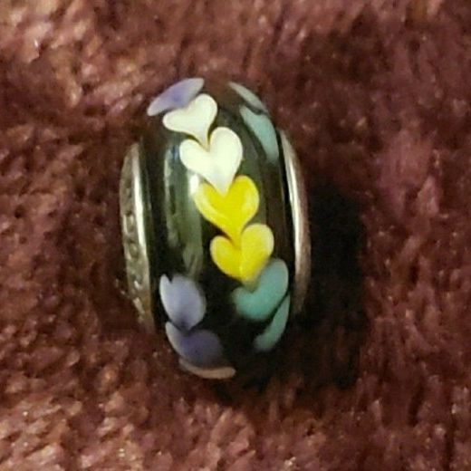 NEW Authentic Pandora Murano Glass Charm Bead.  Black with Purple, Yellow, White & Green Hearts.  Hallmarked PANDORA S925 ALE.  I have 2 available.  P