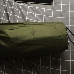 Ultralight inflatable sleeping pad for camping includes built-in pillow and integrated pump.