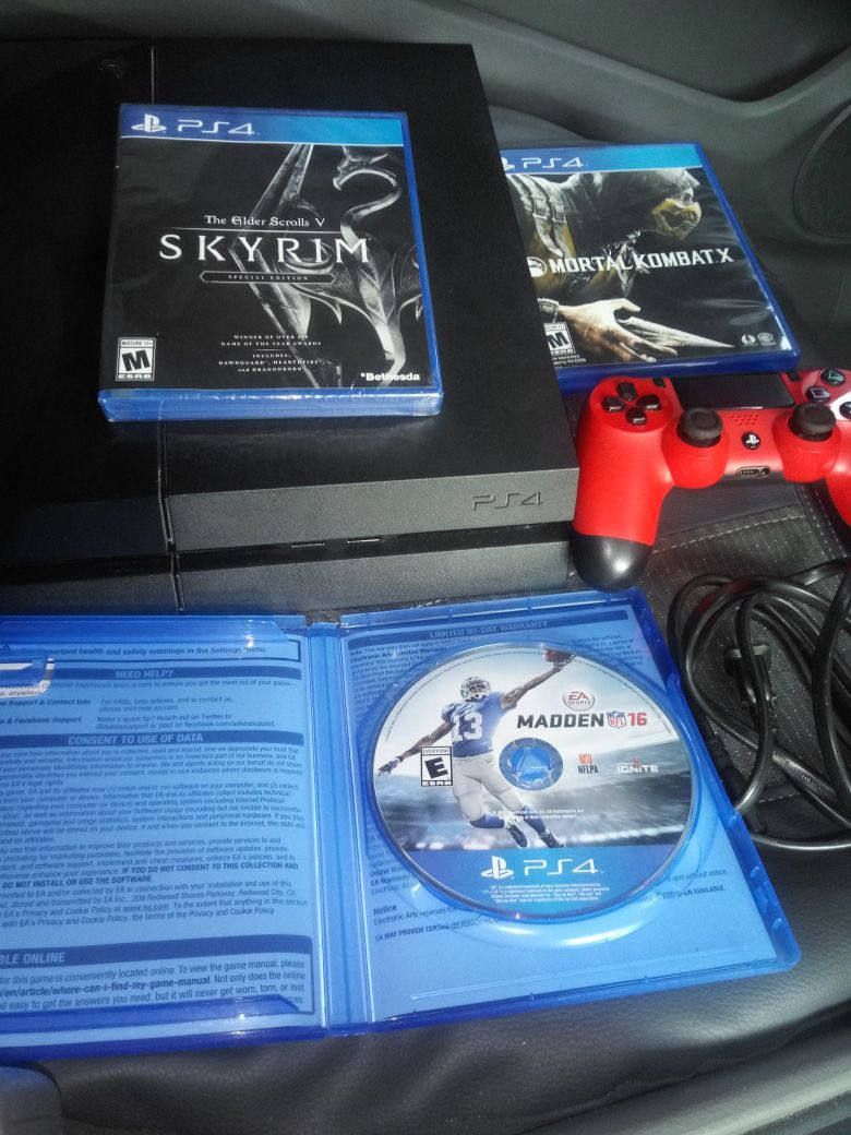 PS4 with red controller and 3 games including Skyrim Special Edition sealed