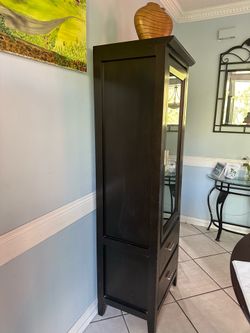 Espresso curio cabinets.