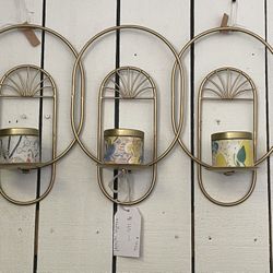 Hanging wall candle holder with three candles in gold