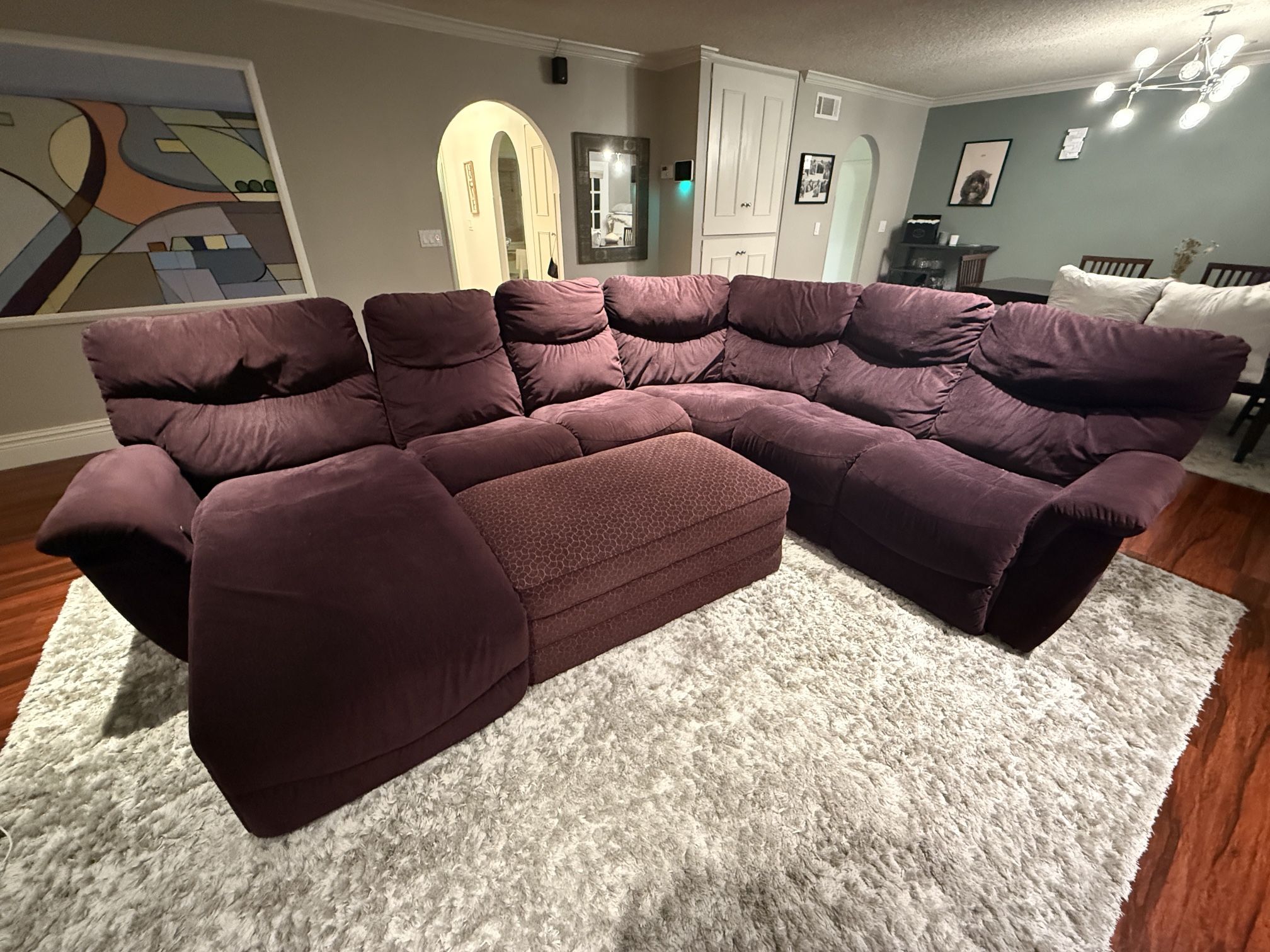 Sectional Sofa In Purple With Reclining Seats And Large Matching Storage Ottoman
