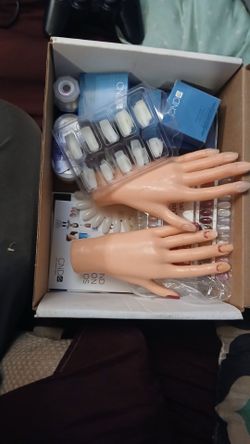 Practice hands and artificial nail kit.